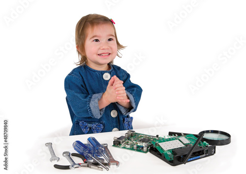 Photo: One small little girl fixing router or modem or PCB. One small little girl fixing router or modem or PCB.