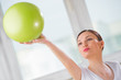 Portrait of fit and healthy gym woman with ball at fitness club