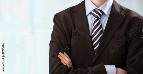Photo: Closeup of torso of confident business man wearing elegant suit Closeup of torso of confident business man wearing elegant suit