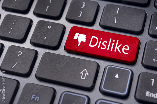 Photo: dislike message on keyboard button, antisocial media concepts dislike message on keyboard button, antisocial media concepts