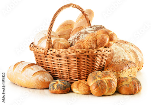 Photo: Bread and rolls in wicker basket isolated on white Bread and rolls in wicker basket isolated on white
