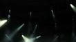 Spotlights turning and shining on floating smoke in an empty dar
