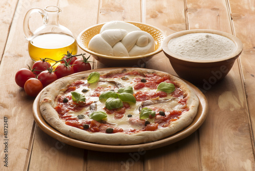 Photo: pizza with ingredients on wooden table pizza with ingredients on wooden table