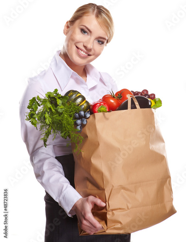 Photo: Portrait of happy business woman holding a shopping bag full of Portrait of happy business woman holding a shopping bag full of