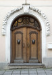 Photo: Old brown wooden door with metal panther heads ornaments Old brown wooden door with metal panther heads ornaments