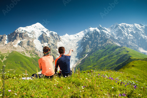 Photo: Hiker take a rest during hiking in Caucasus mountains, Georgia Hiker take a rest during hiking in Caucasus mountains, Georgia