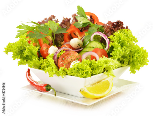 Photo: Vegetable salad bowl isolated on white Vegetable salad bowl isolated on white