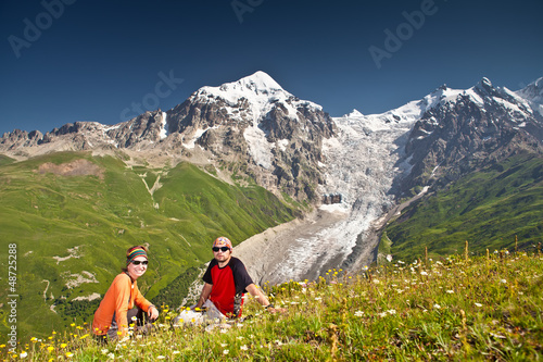 Photo: Hiker take a rest during hiking in Caucasus mountains, Georgia Hiker take a rest during hiking in Caucasus mountains, Georgia