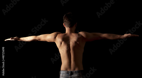 Photo: Shirtless young man with arms outstretched Shirtless young man with arms outstretched
