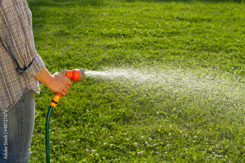 Photo: Watering the lawn with spray gun Watering the lawn with spray gun