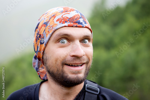 Photo: Portrait of the hiker against green background Portrait of the hiker against green background