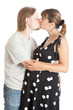 happy young pregnant woman and her husband kissing