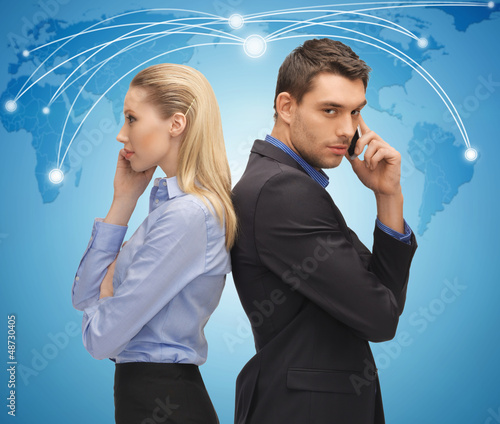 Photo: man and woman with cell phones man and woman with cell phones