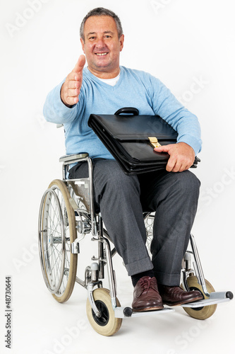 Photo: Friendly man in wheelchair holding thumbs up Friendly man in wheelchair holding thumbs up