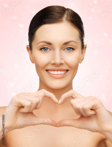Photo: woman showing heart shape woman showing heart shape