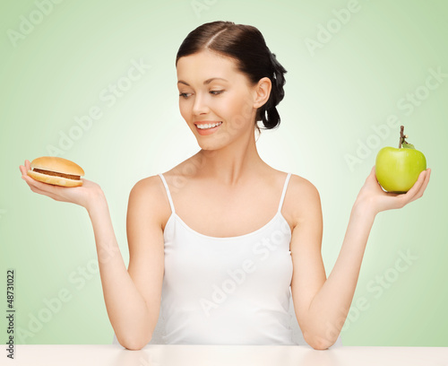 Photo: woman with hamburger and apple woman with hamburger and apple