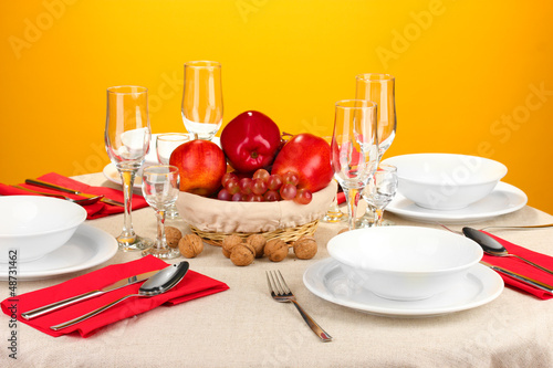 Photo: Table setting in red tones on color background Table setting in red tones on color background