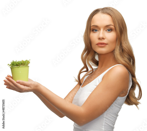 Photo: woman with green grass in pot woman with green grass in pot
