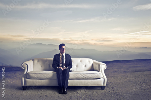 Photo: businessman sitting on sofa businessman sitting on sofa