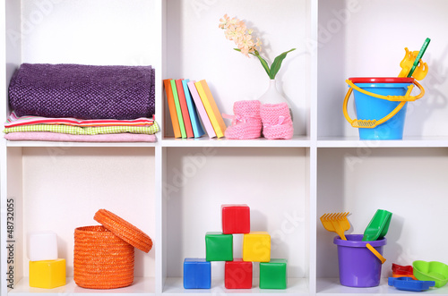 Photo: Beautiful white shelves with different baby related objects Beautiful white shelves with different baby related objects