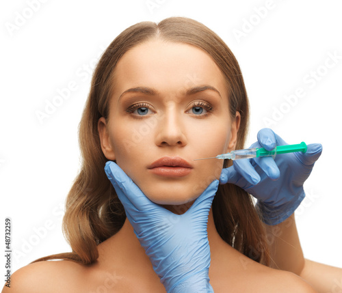Photo: woman face and beautician hands woman face and beautician hands