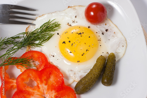 Photo: Fried eggs with cucumbers, tomato, pepper and greens Fried eggs with cucumbers, tomato, pepper and greens
