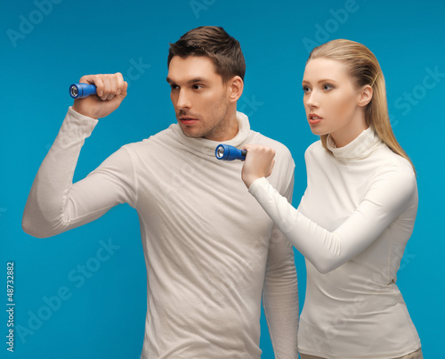 Photo: man and woman with pocket flashlights man and woman with pocket flashlights