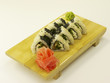 Photo: Delicious sushi rolls on wooden plate Delicious sushi rolls on wooden plate