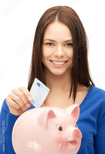 Photo: lovely woman with piggy bank and money lovely woman with piggy bank and money