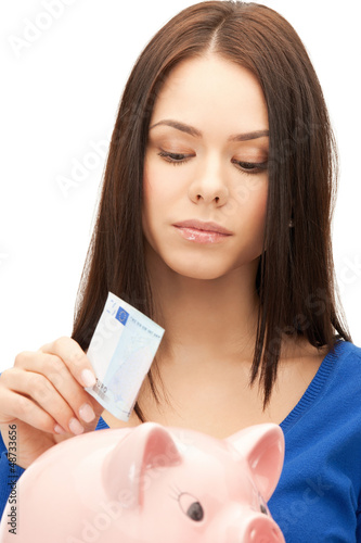 Photo: lovely woman with piggy bank and money lovely woman with piggy bank and money