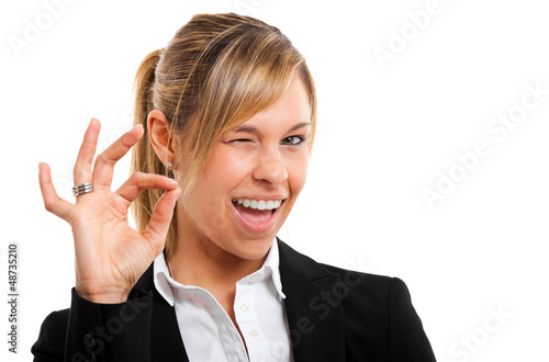 Photo: Successful young business woman doing the ok sign Successful young business woman doing the ok sign