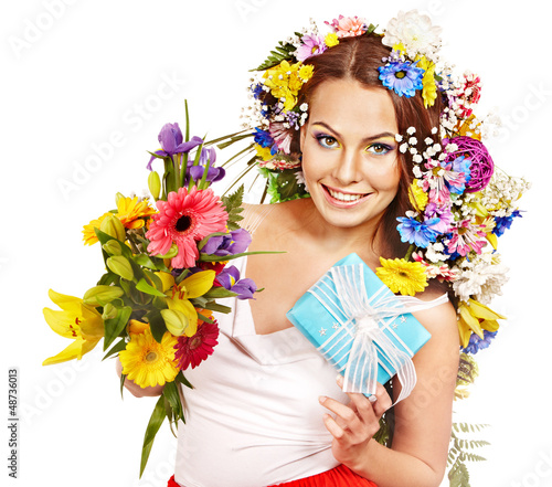 Photo: Woman with gift box and flower bouquet . Woman with gift box and flower bouquet .