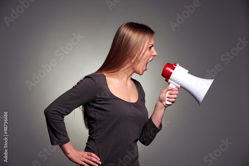Photo: woman shouting in loudspeaker woman shouting in loudspeaker