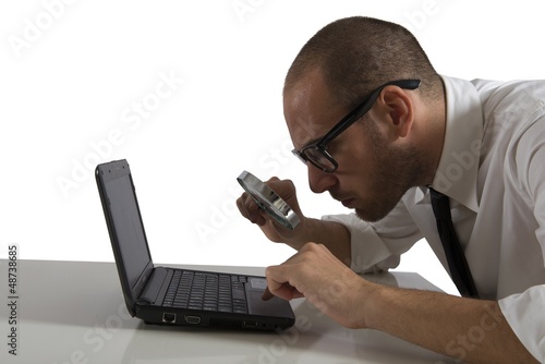 Photo: Businessman looks on the computer with a lens Businessman looks on the computer with a lens
