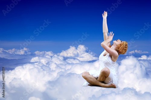 Photo: Ballerina seating on the sky clouds Ballerina seating on the sky clouds
