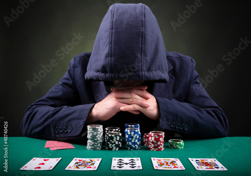 Photo: Poker player on black background Poker player on black background