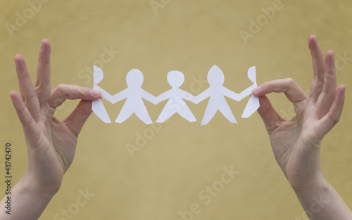 Photo: YOUNG WOMAN HANDS HOLDING PAPER PEOPLE YOUNG WOMAN HANDS HOLDING PAPER PEOPLE