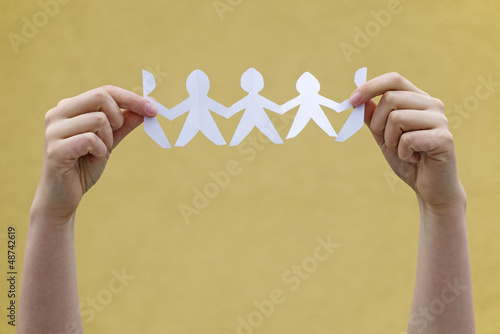 Photo: YOUNG WOMAN HANDS HOLDING PAPER PEOPLE YOUNG WOMAN HANDS HOLDING PAPER PEOPLE