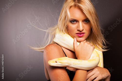Photo: attractive blonde woman holding python on her shoulder attractive blonde woman holding python on her shoulder