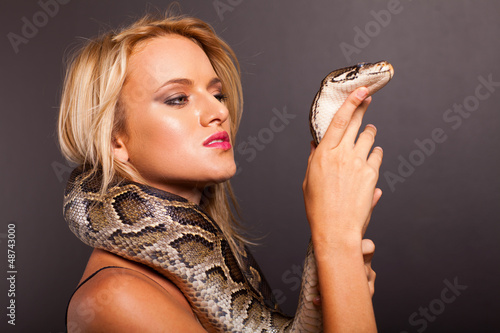 Photo: pretty young woman holding python pretty young woman holding python