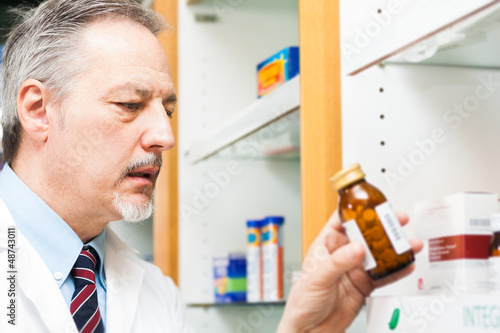 Photo: Man at work in a pharmacy Man at work in a pharmacy