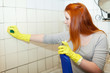 Photo: girl cleans bathroom with sponge girl cleans bathroom with sponge