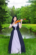 Photo: Woman playing violin in the park Woman playing violin in the park