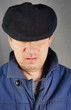 Unshaved man in a black cap