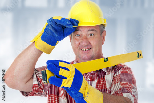 Photo: Friendly construction worker with a spirit level Friendly construction worker with a spirit level