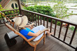 woman relaxed on chair looking on rice fields