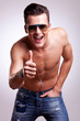 topless model thumbs up sign