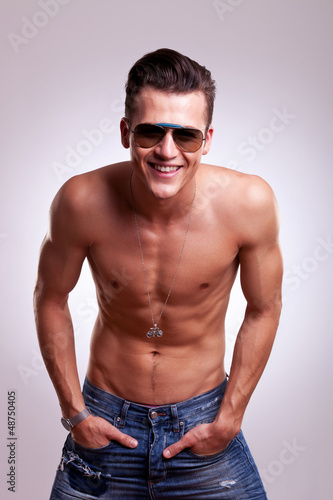 Photo: charming topless man holds hands in pockets charming topless man holds hands in pockets