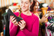 Woman is buying shoes for her Tracht or dirndl in a shop