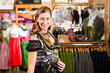 Woman is trying Tracht or dirndl in a shop